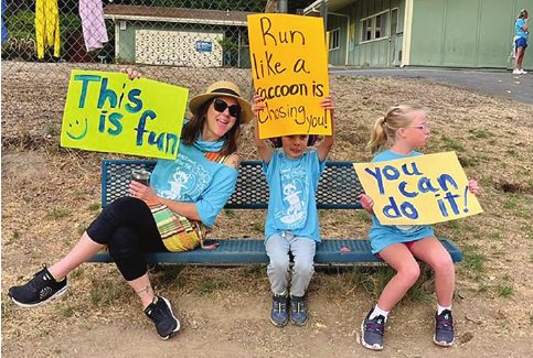 Students holding handmade walk-a-thon signs